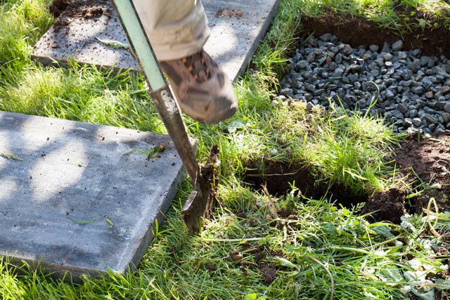 Landscaping installing Paving stones removing grass